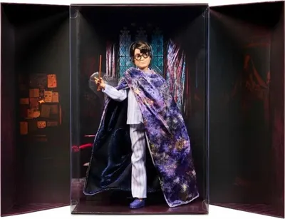 A Harry Potter doll in a display box, holding a wand.