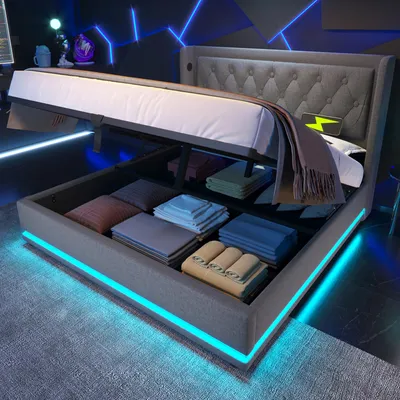 A modern bedroom with a bed that has storage and LED lighting.