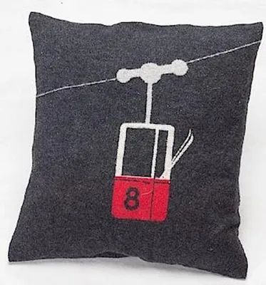 A square pillow with a graphic of a ski gondola.