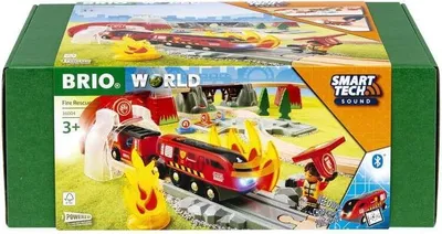 The image shows the packaging of a BRIO World Smart Tech Sound Fire Rescue Set. The packaging displays a vibrant scene of the toy train set in action, with fire elements and a firefighter figure.