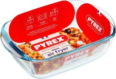 A Pyrex glass baking dish with a food item inside, presented with marketing labels and packaging.