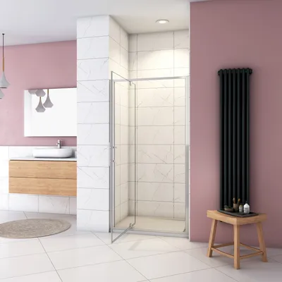 A modern bathroom with a shower enclosure, sink, and radiator.