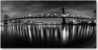 Produktbild von Tulup® Leinwandbild -100x50 cm - Wandkunst - Drucke auf Leinwand - Leinwanddruck  - Sehenswürdigkeiten & Architektur - Schwarzweiß - Manhattan bei Nacht