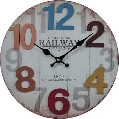 A round wall clock with colorful numbers and text indicating it's from the Caledonian Railway, Central Station Glasgow, established in 1879.