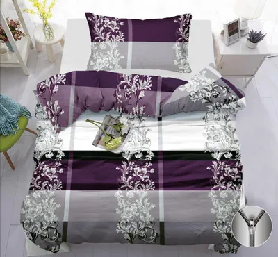 A neatly made bed with a duvet cover and pillow, styled with a small book and flowers.