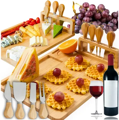 A cheese board set with various cheeses, grapes, waffles, and a bottle of wine.