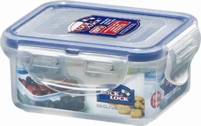 A clear plastic food storage container with a blue lid.