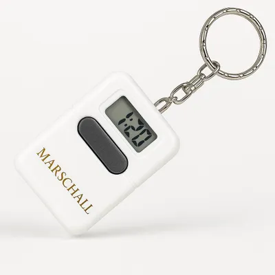 A white digital keychain clock with a silver keyring and chain, displayed on a white background.