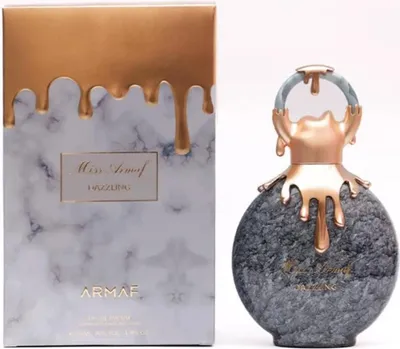 A perfume bottle and its packaging are displayed side-by-side against a white background.