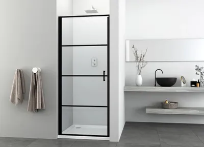 A modern bathroom with a black framed glass shower door.
