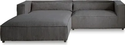 A dark gray sectional sofa with a chaise lounge.