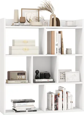 A white bookshelf filled with decorative items and books.