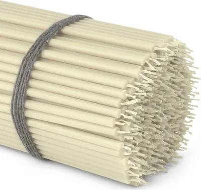 A bundle of thin white candles tied with a grey string.