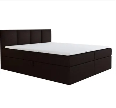 A dark brown boxspring bed with a white mattress and a tufted headboard, presented against a white background.