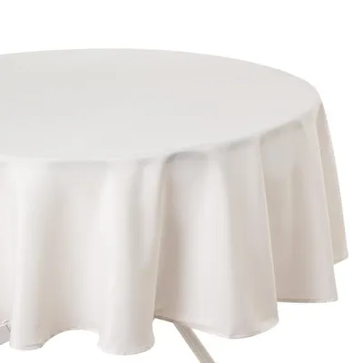 A close-up of a round, white tablecloth draped over a table.
