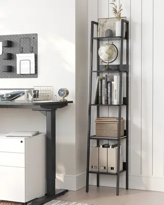 A home office setup with a standing desk and a ladder shelf.