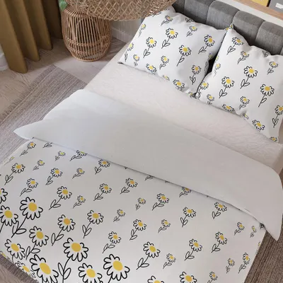 A bed with white bedding featuring a daisy pattern.
