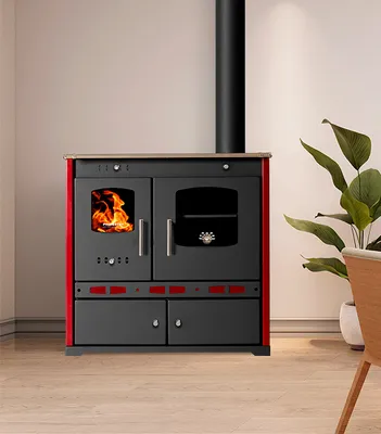 A wood-burning stove with a chimney, set against a plain wall.
