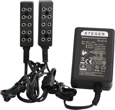 A black power adapter and two black light modules for a dollhouse.