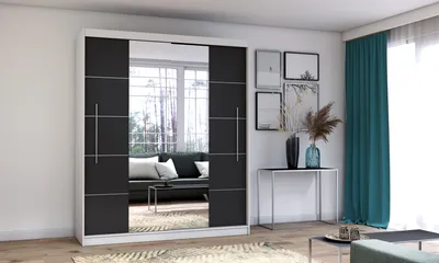 A modern bedroom or living room with a large sliding door wardrobe, a console table with decorative items, and teal curtains.