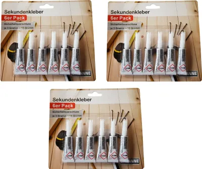 Three packages of instant glue tubes are displayed on a light brown wooden background.