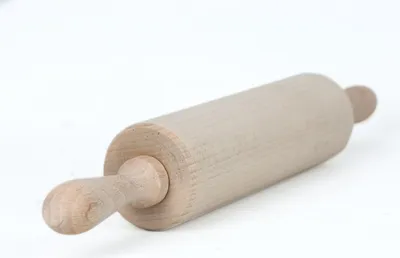 A wooden rolling pin on a white background.