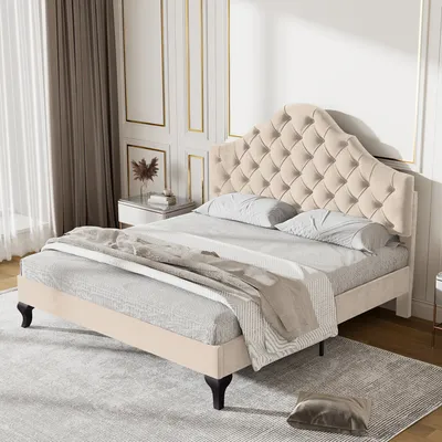 A tufted beige bed in a well-lit room with decorative wall paneling.