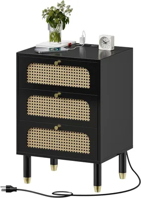 A black nightstand with rattan drawer fronts and gold accents, shown on a white background.