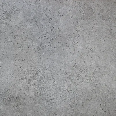 A close-up, textured view of a gray concrete-like surface.