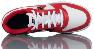 A top-down view of a Nike shoe on a reflective surface.