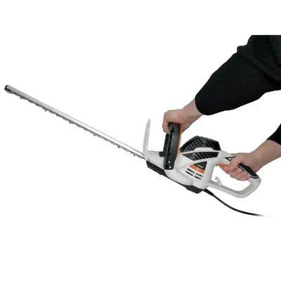 A person is holding a hedge trimmer.