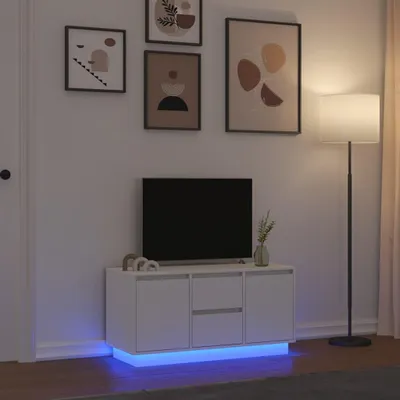 A white TV stand with LED lighting in a room.