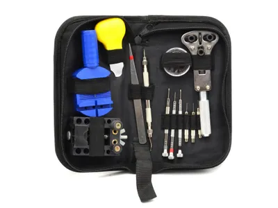A black zippered case containing a set of watchmaking tools.