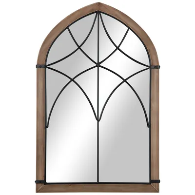 A decorative arched mirror with a wooden frame and black metal detailing.