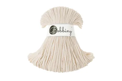 A spool of cream-colored macrame cord with a label.