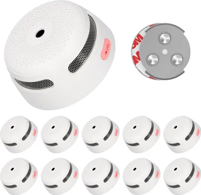 A collection of white smoke detectors and a mounting bracket with adhesive backing.