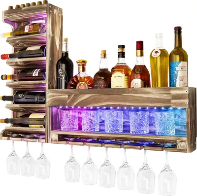 A wooden wine rack filled with bottles and glasses, illuminated by LED lights.