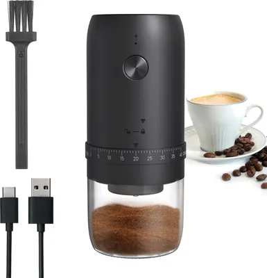 A black electric coffee grinder with a clear container showing coffee grounds, accompanied by a cleaning brush and USB cables, next to a cup of coffee and coffee beans.