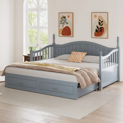 A gray daybed with storage drawers is shown in a room with two abstract art pieces on the wall and a large window in the background.