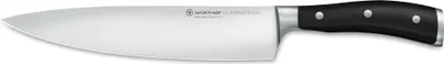 A chef's knife with a silver blade and a black handle is shown against a white background.