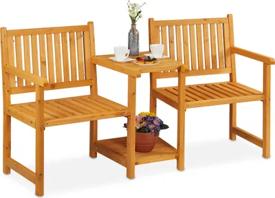A wooden garden bench set with a small table in between, set against a white background.