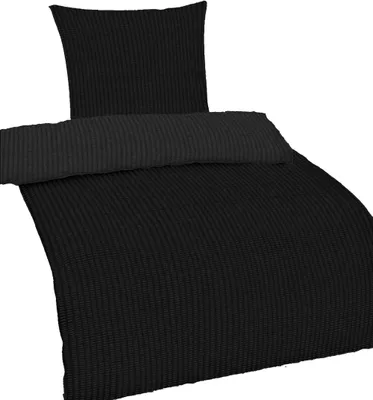 A black seersucker duvet and pillowcase set displayed on a white background.