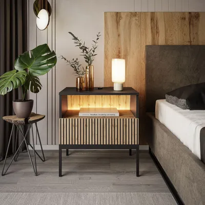 A modern bedroom scene featuring a nightstand with a lamp, plant, and book.