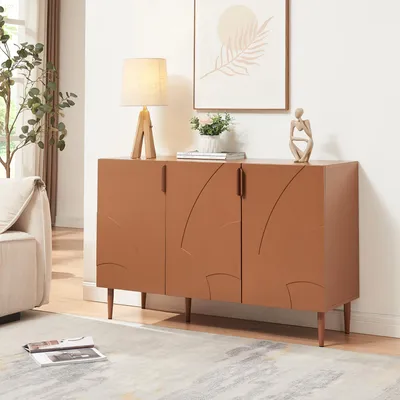 A modern living room scene featuring a rust-colored sideboard with decorative doors, a table lamp, a small plant, and a decorative figurine.