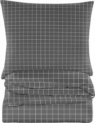 A stack of folded bedding with a grid pattern.