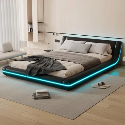 A modern bedroom with a black platform bed featuring blue LED lighting.