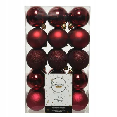 A package of red Christmas ornaments in a clear plastic box.