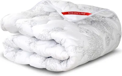 A folded white blanket with a gray floral pattern is shown against a white background.