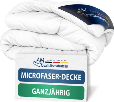 A folded white duvet or blanket is displayed against a white background, with a label attached to it.