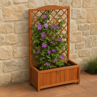 A wooden planter with a trellis, containing a flowering plant, is placed against a stone wall on a tiled patio.
